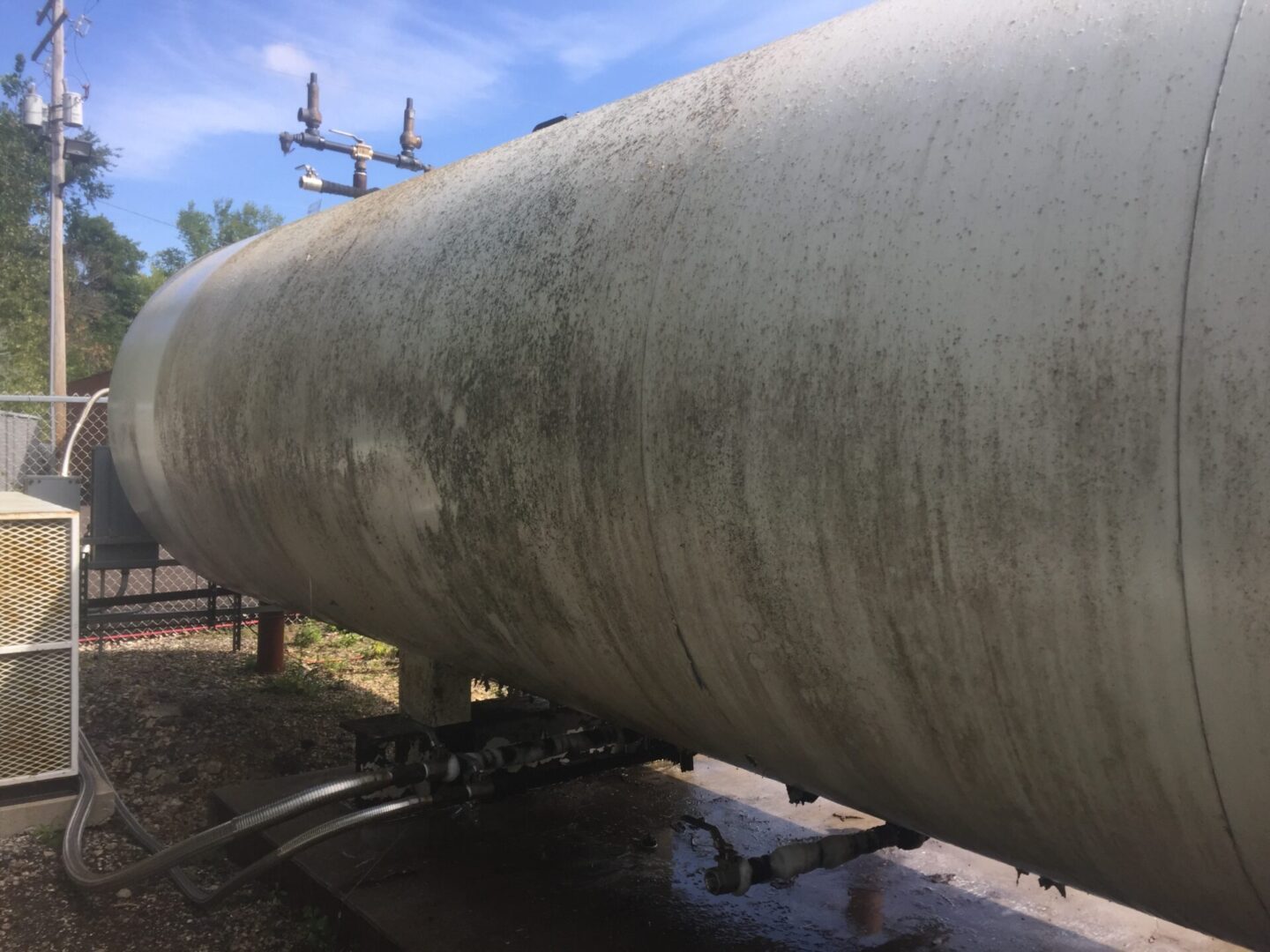 A large pipe sitting on top of a road.